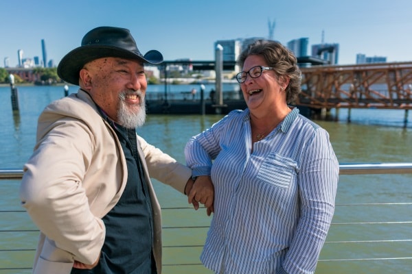 Old couple laughing at wharf
