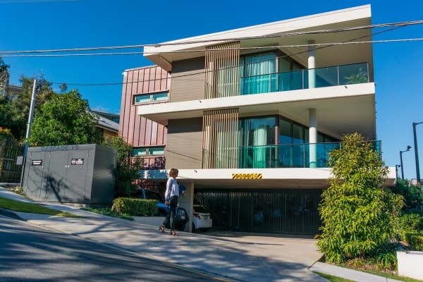 Woman walking past an apartment