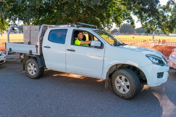 Man driving a ute smiling